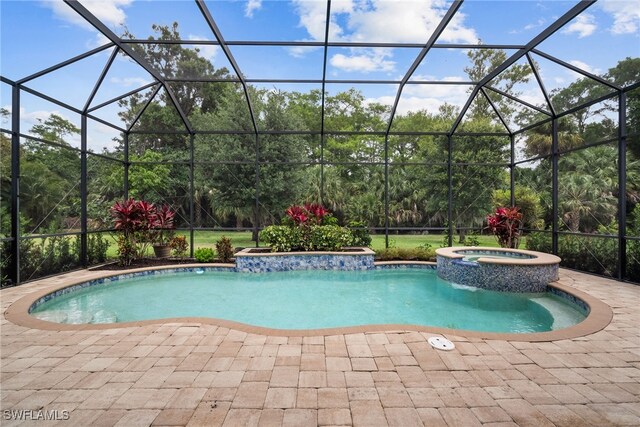 view of pool with an in ground hot tub, glass enclosure, and a patio area