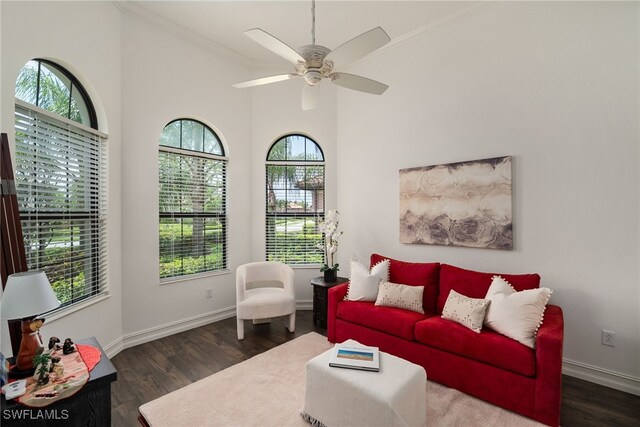 living room with ceiling fan, ornamental molding, and dark hardwood / wood-style floors