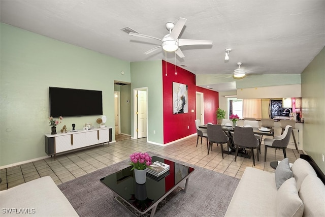 living room featuring tile patterned flooring, ceiling fan, and lofted ceiling