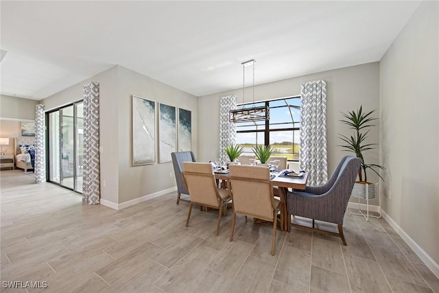 dining space featuring baseboards and wood finish floors