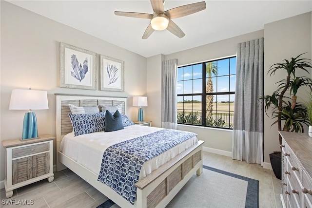 bedroom featuring a ceiling fan and baseboards