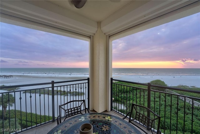 balcony with a beach view and a water view