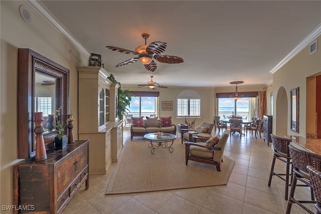 tiled living room with ceiling fan and ornamental molding