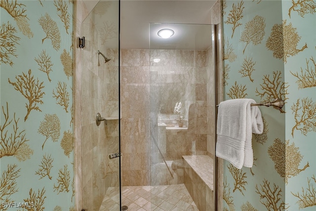 bathroom featuring a shower with door