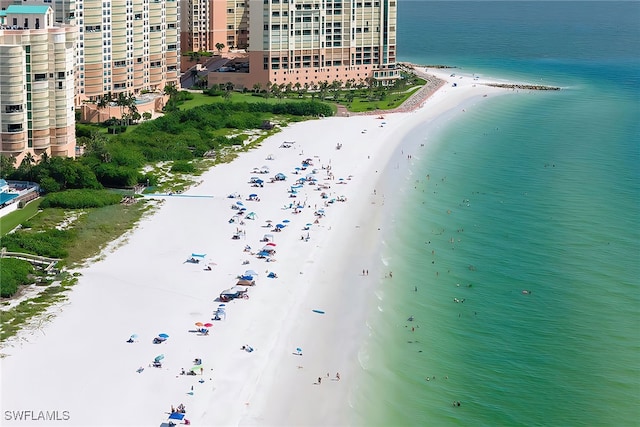 drone / aerial view with a water view and a beach view