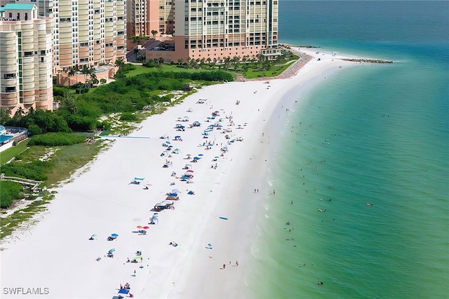 birds eye view of property with a view of the beach and a water view