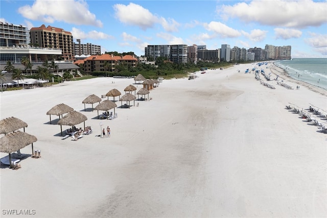 birds eye view of property with a water view and a view of the beach