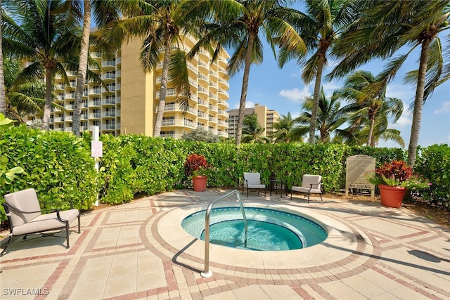 view of pool with a patio and a community hot tub