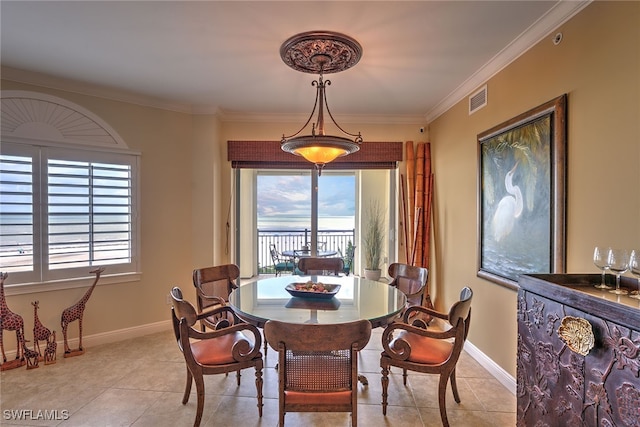 dining space featuring ornamental molding and light tile patterned floors