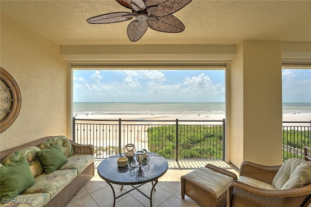 exterior space featuring a view of the beach, a healthy amount of sunlight, and a water view