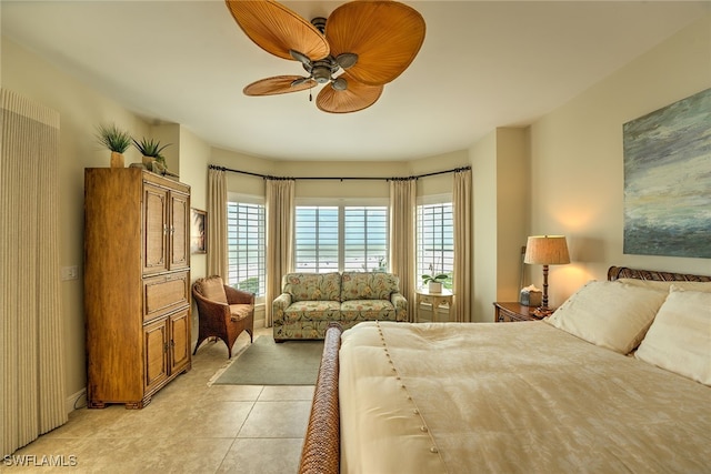 bedroom with ceiling fan and light tile patterned flooring