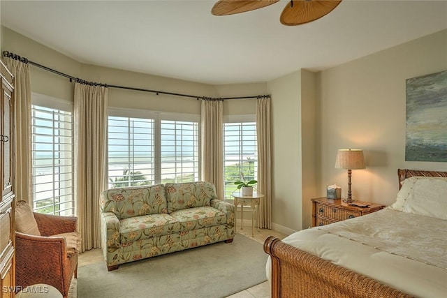 bedroom featuring light carpet and a ceiling fan