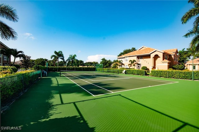 view of sport court featuring fence