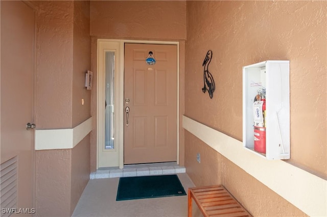 property entrance featuring stucco siding