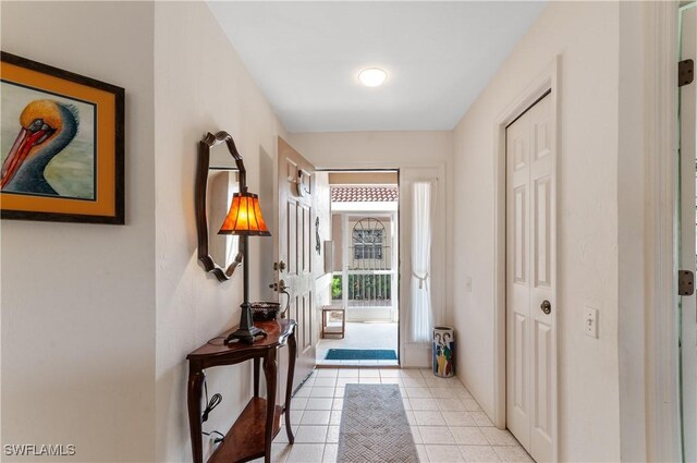 doorway to outside featuring light tile patterned floors