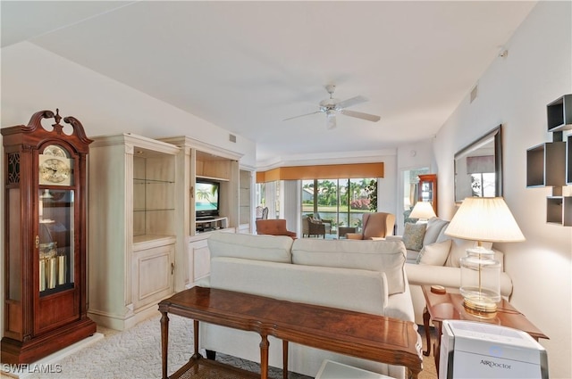 living room featuring ceiling fan, visible vents, and light colored carpet