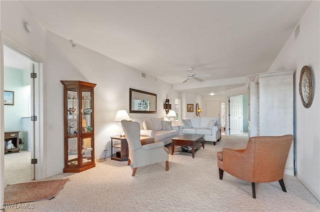 carpeted living area with visible vents and ceiling fan