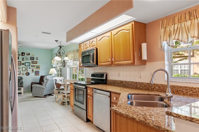 kitchen featuring a wealth of natural light, visible vents, appliances with stainless steel finishes, and a sink