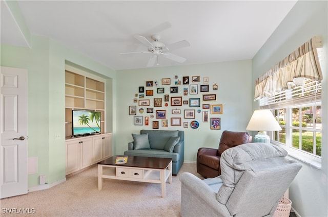 living area featuring ceiling fan and light carpet