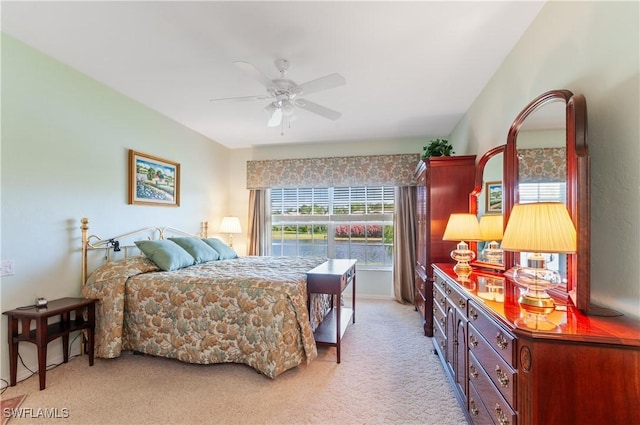 bedroom featuring a ceiling fan and light carpet