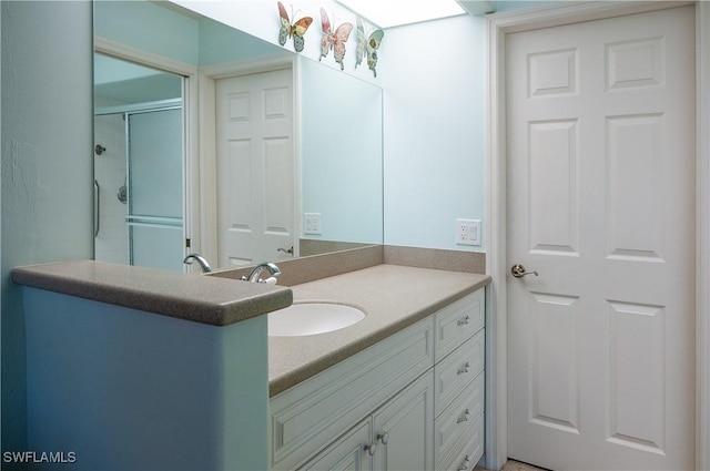 full bath featuring vanity and a shower with shower door