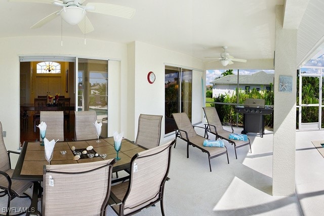 view of patio featuring a ceiling fan, outdoor dining space, and a grill