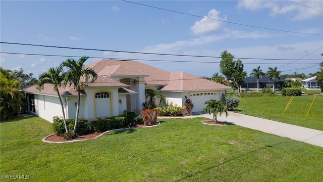 view of front of house featuring a garage, driveway, a front lawn, and stucco siding