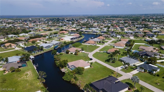 drone / aerial view with a water view and a residential view