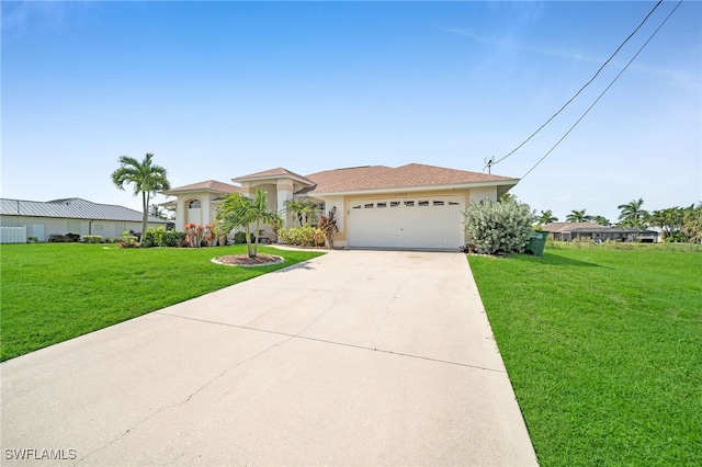 view of front of home with a garage, concrete driveway, a front yard, and stucco siding