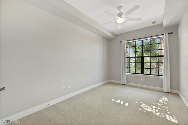 spare room featuring ceiling fan and light colored carpet