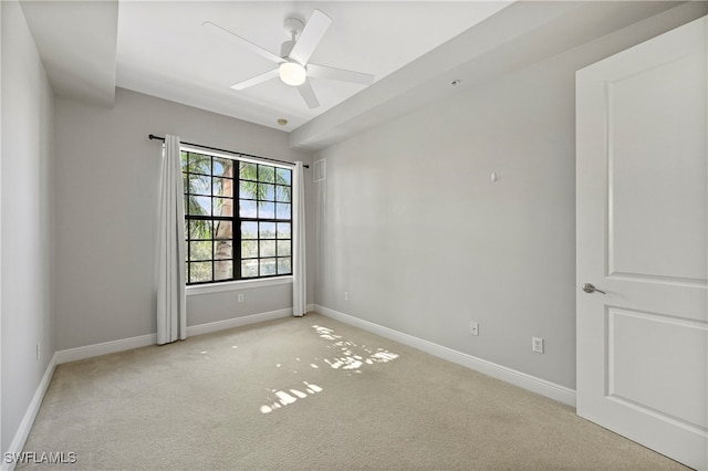 unfurnished room with ceiling fan and light carpet