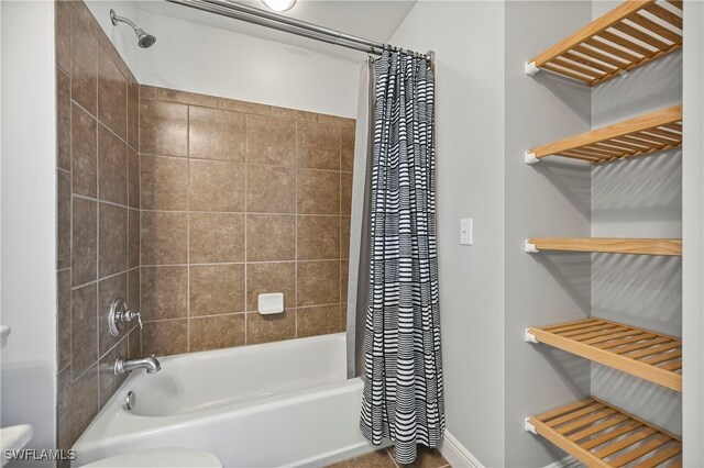 bathroom featuring shower / bath combo and toilet