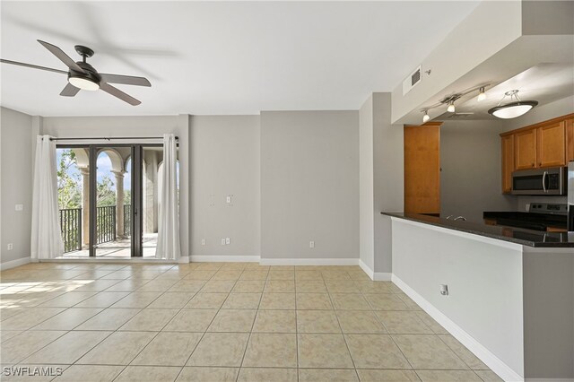 interior space with ceiling fan and light tile patterned floors