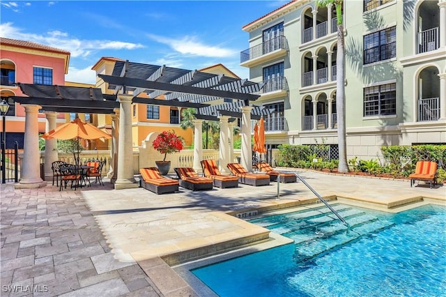 pool with a fire pit, a patio, and a pergola