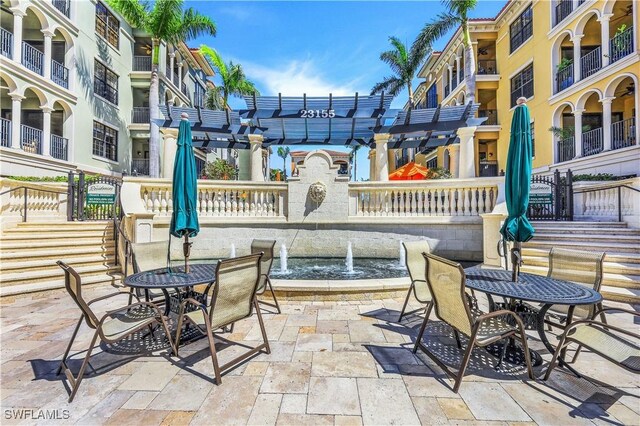 view of patio with a pergola and a balcony