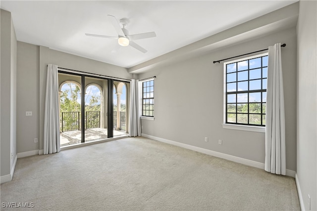 empty room featuring carpet, ceiling fan, and baseboards