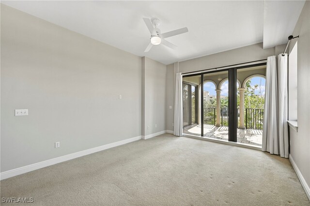 empty room with ceiling fan and light colored carpet