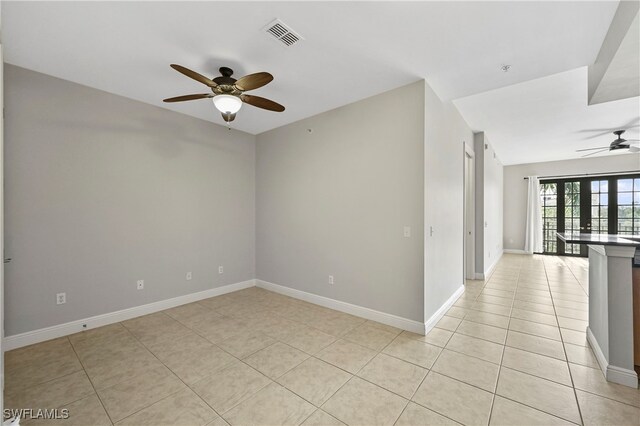 unfurnished room with ceiling fan, french doors, and light tile patterned floors