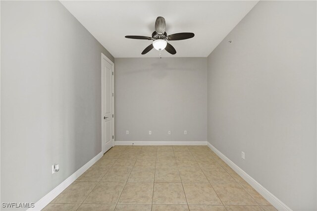 tiled spare room featuring ceiling fan