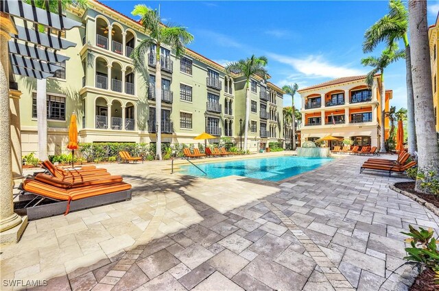 view of pool with pool water feature and a patio area