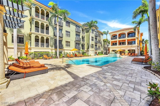 community pool with a patio area