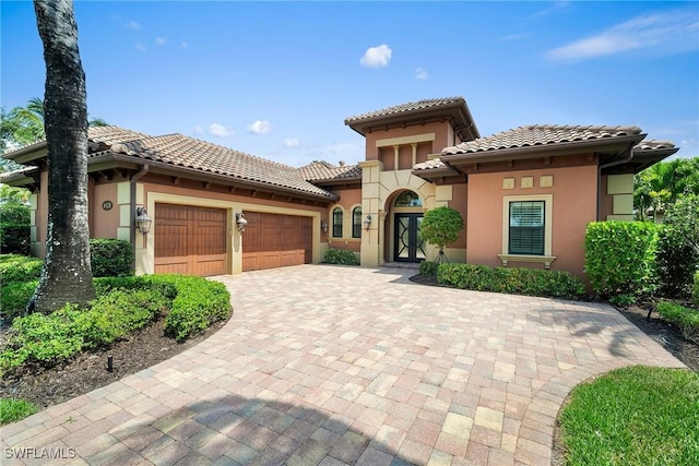 mediterranean / spanish home featuring a garage