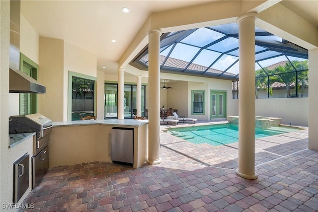 view of pool featuring a lanai, exterior kitchen, a bar, grilling area, and a patio area