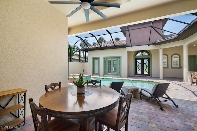 view of patio / terrace with french doors, glass enclosure, ceiling fan, and a swimming pool with hot tub