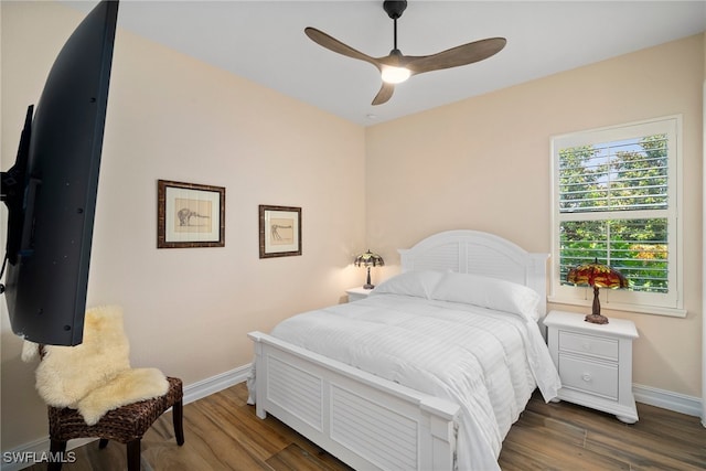 bedroom featuring ceiling fan and dark wood-type flooring