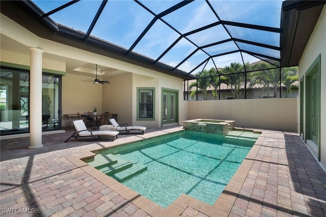 view of pool featuring an in ground hot tub, a patio area, ceiling fan, and a lanai