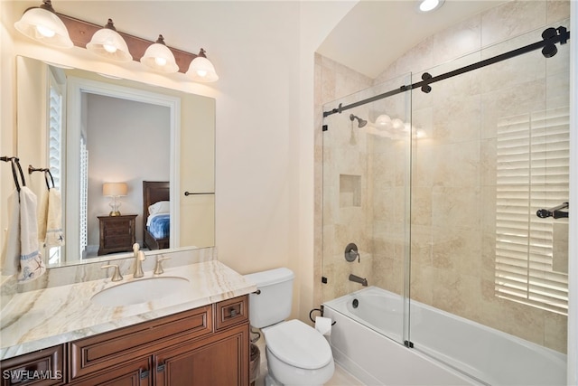 full bathroom with vanity, enclosed tub / shower combo, and toilet