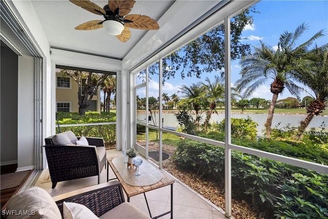 sunroom / solarium with a water view and ceiling fan