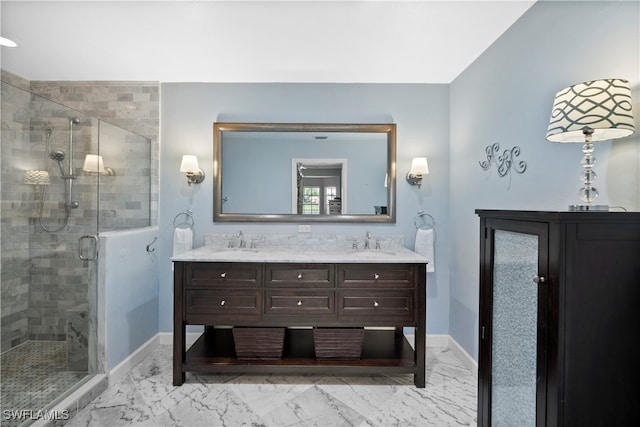 bathroom with a shower with shower door and vanity