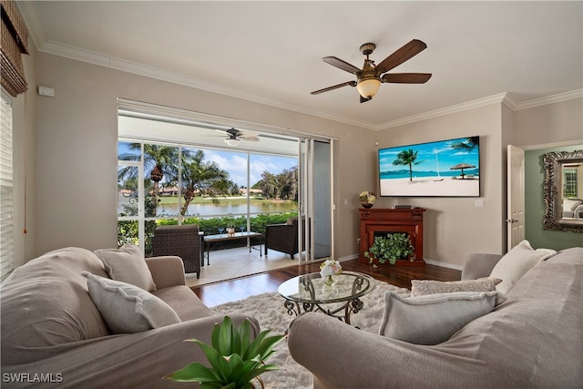 living room featuring wood-type flooring, ceiling fan, and crown molding